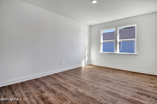 empty room with dark hardwood / wood-style flooring