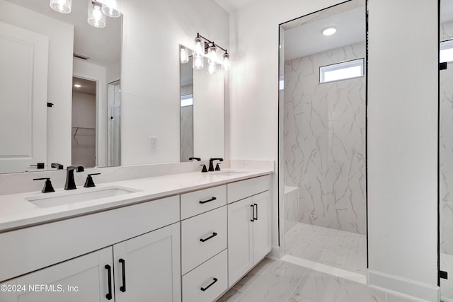 bathroom with tiled shower and vanity