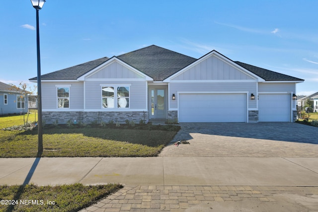 view of front of property with a garage and a front lawn