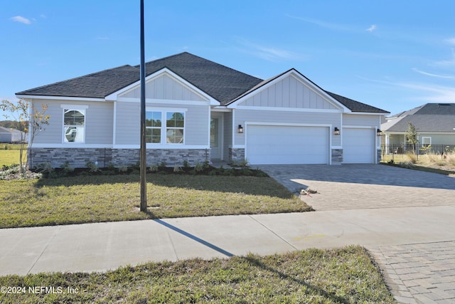 view of front of house with a garage and a front lawn