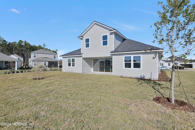 back of house with a lawn