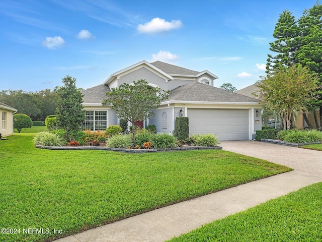 view of front of home with a garage and a front lawn