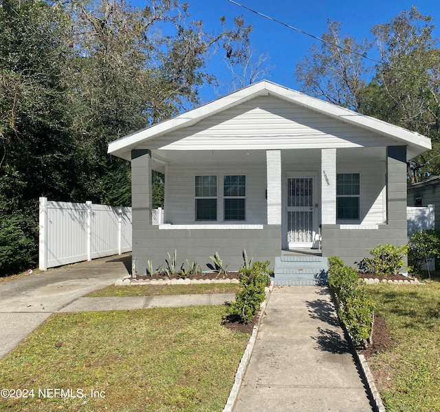 bungalow with a porch and a front yard