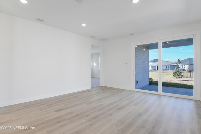 spare room featuring light hardwood / wood-style floors