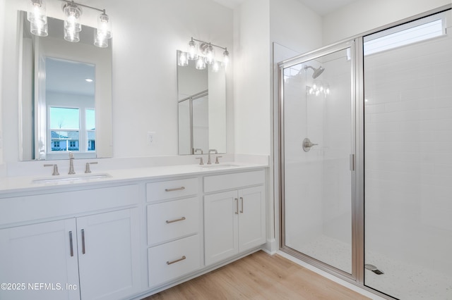 bathroom with vanity, hardwood / wood-style flooring, and walk in shower