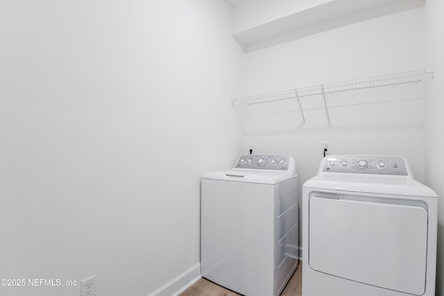 laundry area featuring separate washer and dryer and light wood-type flooring