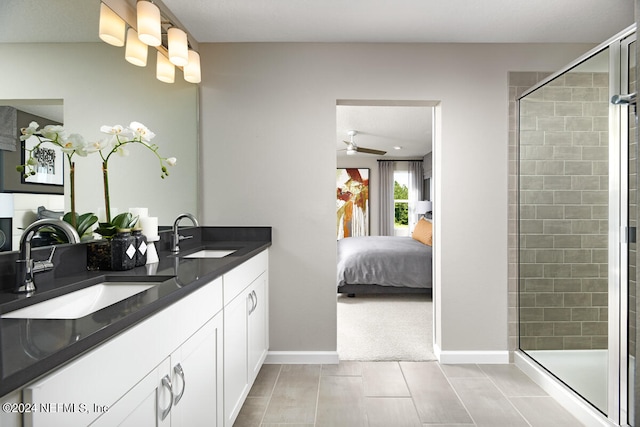 bathroom with an enclosed shower, vanity, and ceiling fan