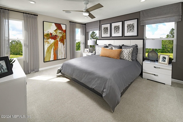 bedroom featuring light carpet and ceiling fan