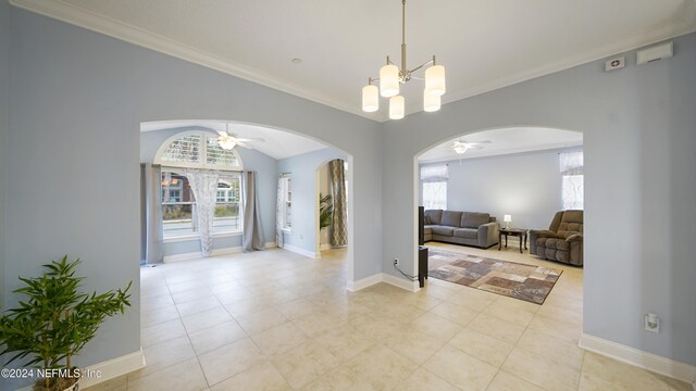 foyer with ceiling fan with notable chandelier, light tile patterned flooring, and crown molding