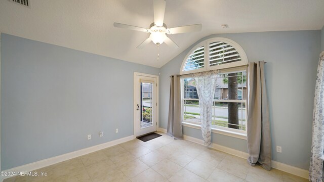 unfurnished room with ceiling fan and vaulted ceiling