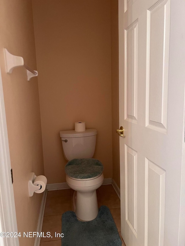 bathroom featuring tile patterned flooring and toilet