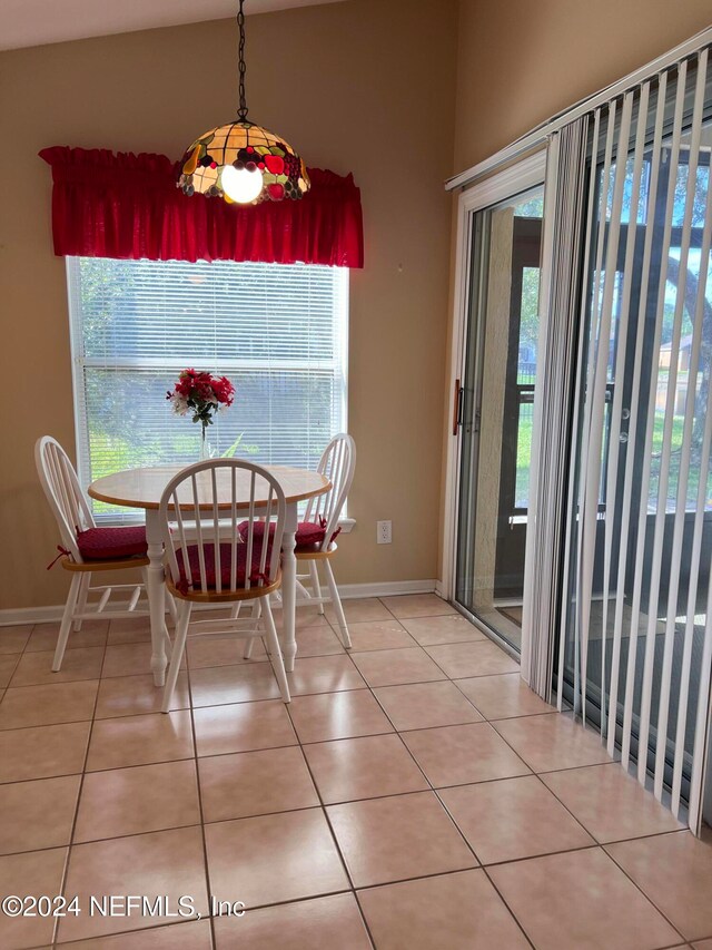 dining room with a healthy amount of sunlight and light tile patterned floors