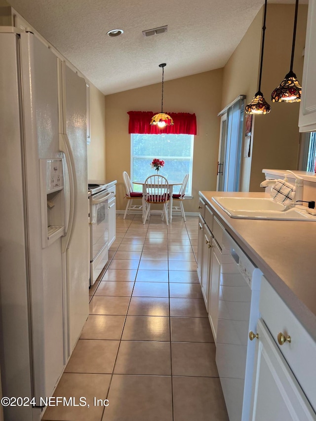 kitchen with white cabinetry, sink, white appliances, decorative light fixtures, and lofted ceiling