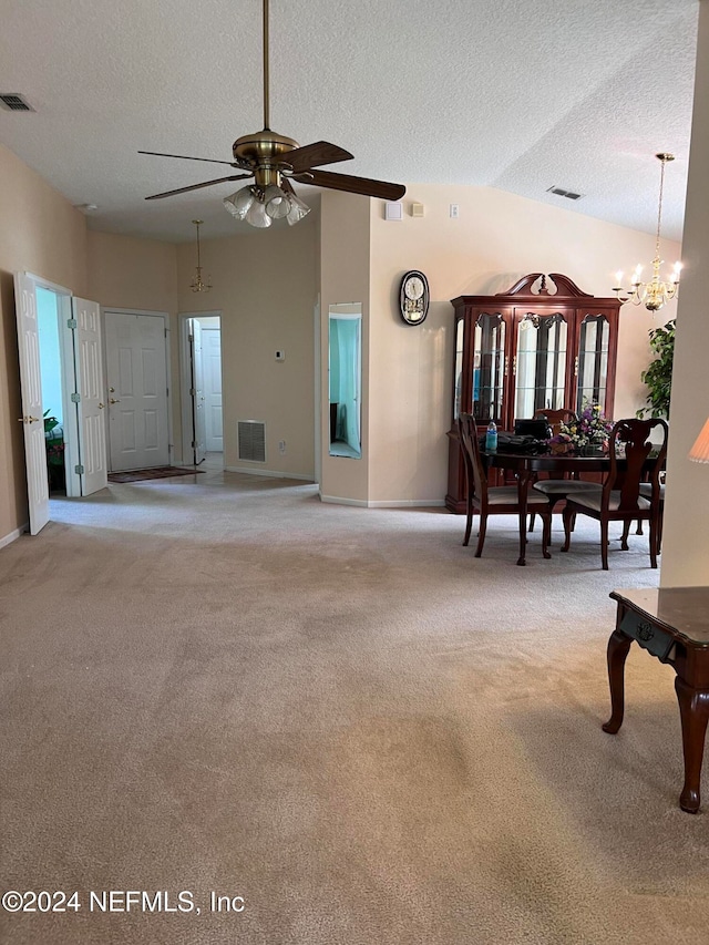 living room with a textured ceiling, ceiling fan with notable chandelier, light colored carpet, and lofted ceiling