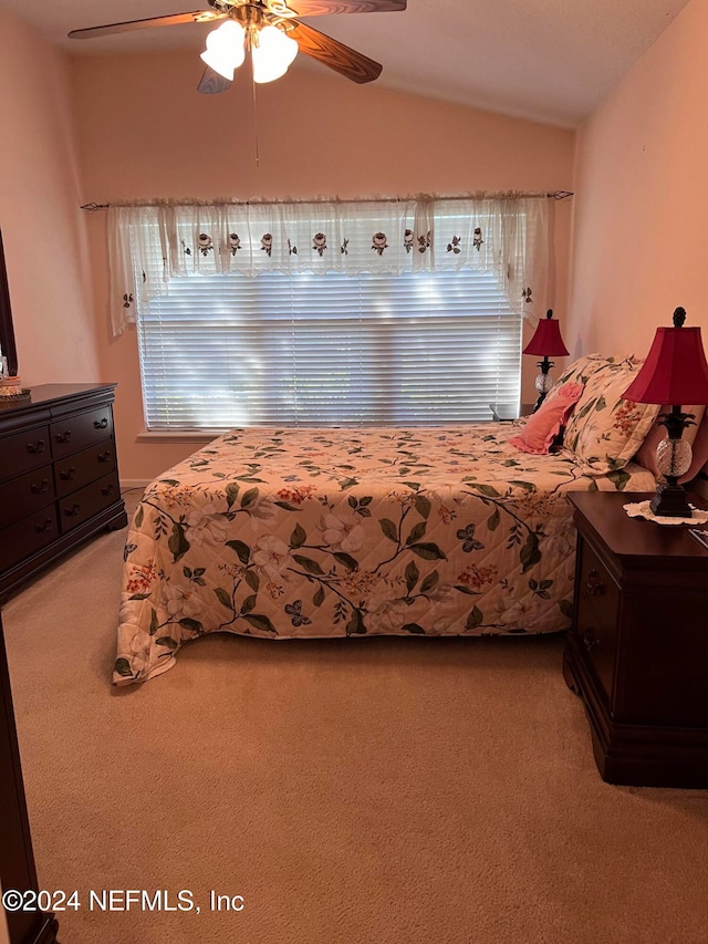 bedroom featuring ceiling fan, carpet floors, and lofted ceiling