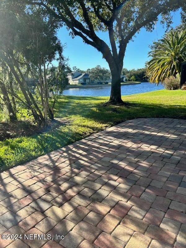 view of home's community featuring a yard and a water view