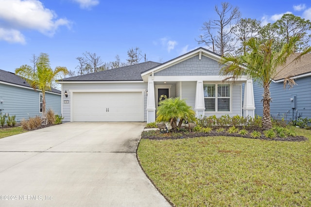 view of front of property with a front lawn and a garage