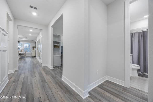 corridor with hardwood / wood-style floors