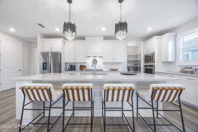 94 Hickory Pine Dr, Saint Augustine, FL 32092 - kitchen with stainless steel appliances, premium range hood, a chandelier, white cabinets, and recessed lighting