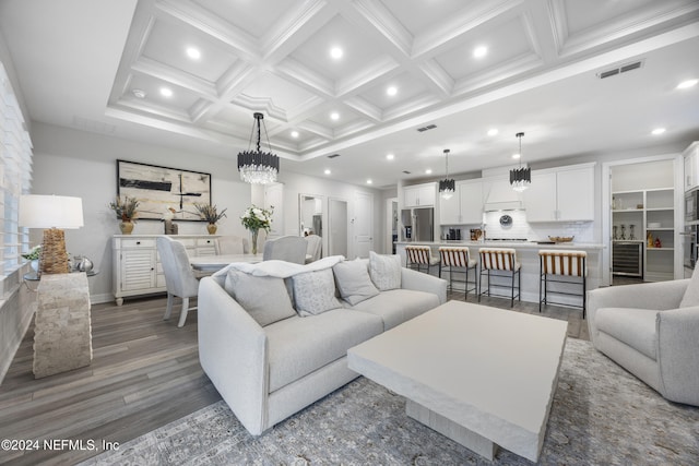 living room with beam ceiling, dark wood-type flooring, and coffered ceiling