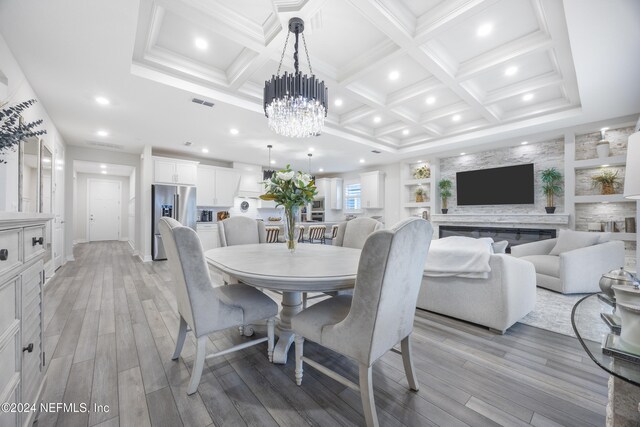 94 Hickory Pine Dr, Saint Augustine, FL 32092 - dining space featuring recessed lighting, coffered ceiling, light wood-style floors, a chandelier, and ornamental molding
