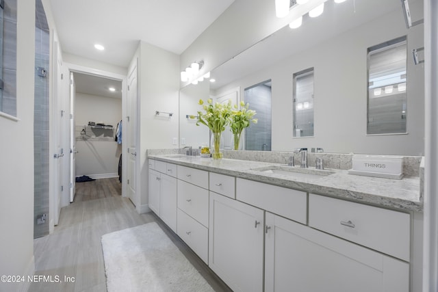 94 Hickory Pine Dr, Saint Augustine, FL 32092 - full bathroom with a shower stall, double vanity, a spacious closet, recessed lighting, and baseboards