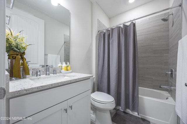 full bathroom featuring vanity, shower / tub combo, and toilet