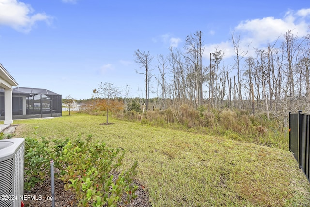 94 Hickory Pine Dr, Saint Augustine, FL 32092 - view of grassy yard featuring central AC and glass enclosure