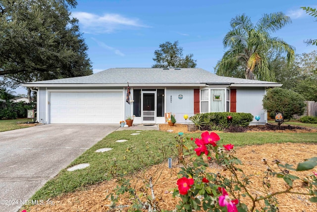 ranch-style home featuring a front yard and a garage