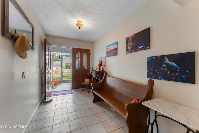 tiled foyer entrance featuring a textured ceiling