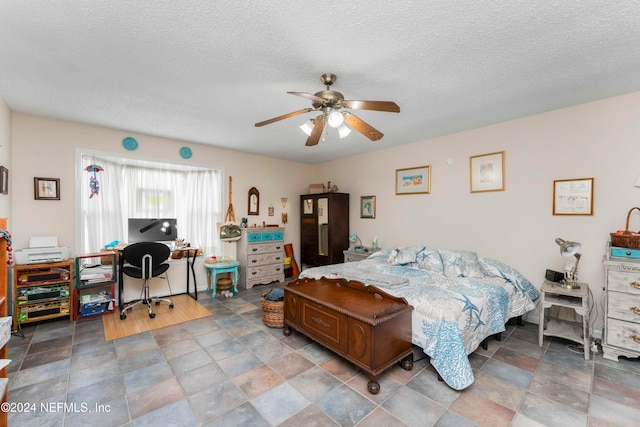 bedroom featuring a textured ceiling and ceiling fan