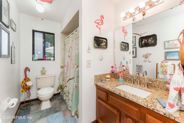 bathroom with curtained shower, vanity, a textured ceiling, and toilet