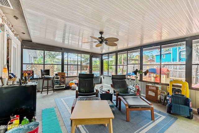 sunroom featuring ceiling fan and a healthy amount of sunlight