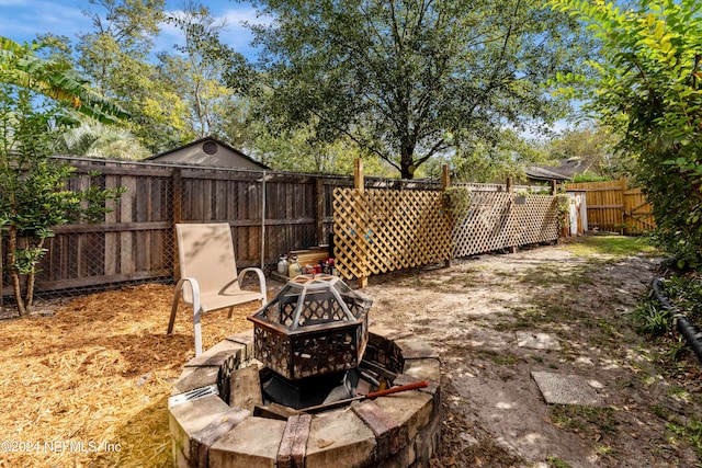 view of yard with an outdoor fire pit