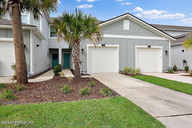 108 Coastline Way, Saint Augustine, FL 32092 - view of front facade featuring board and batten siding, a garage, and concrete driveway