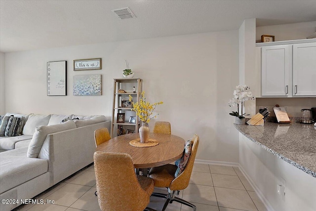 dining area with light tile patterned flooring