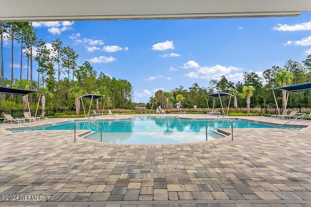 view of swimming pool featuring a patio area