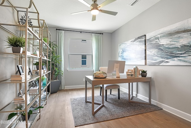 office space featuring ceiling fan and light hardwood / wood-style flooring