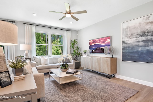 living room with hardwood / wood-style flooring and ceiling fan