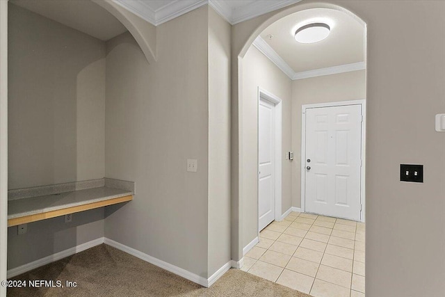 interior space featuring light tile patterned flooring and ornamental molding