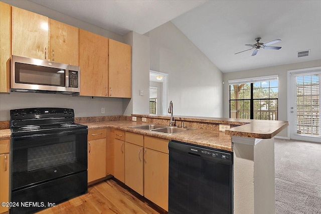 kitchen featuring kitchen peninsula, vaulted ceiling, sink, black appliances, and light hardwood / wood-style floors