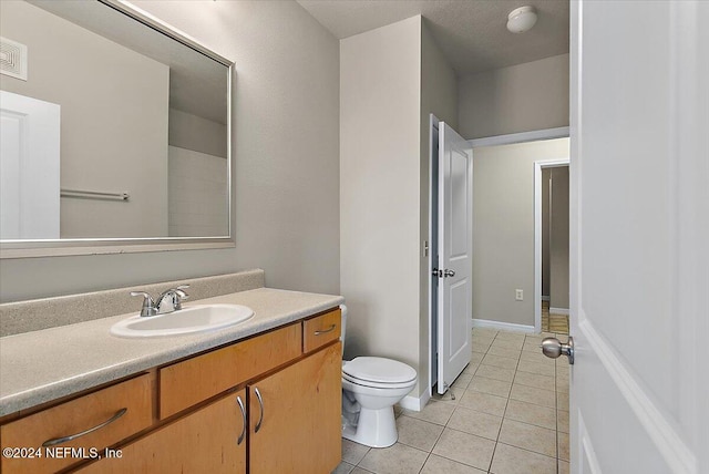 bathroom featuring tile patterned floors, vanity, and toilet