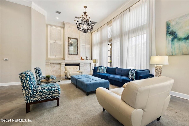 living room with crown molding, a fireplace, and a notable chandelier