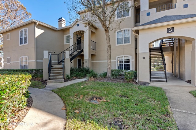 1701 The Greens Way Unit 311, Jacksonville Beach, FL 32250 - view of building exterior featuring stairway