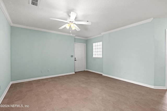 spare room with ceiling fan, crown molding, and a textured ceiling