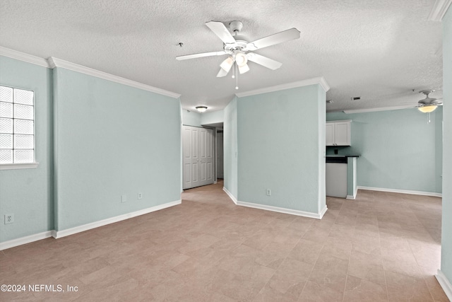 spare room with a textured ceiling, ceiling fan, and crown molding