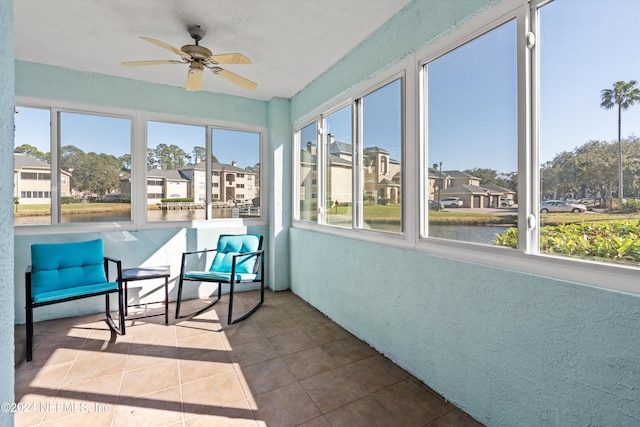 sunroom / solarium featuring ceiling fan and a healthy amount of sunlight