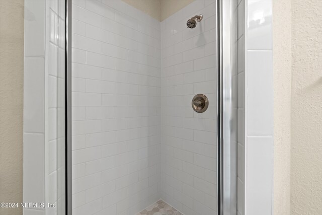 1701 The Greens Way Unit 311, Jacksonville Beach, FL 32250 - bathroom with a shower stall and a textured wall