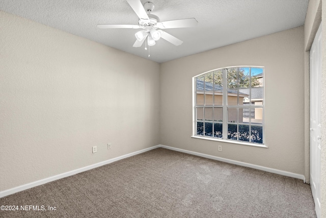 empty room featuring carpet, ceiling fan, and a textured ceiling