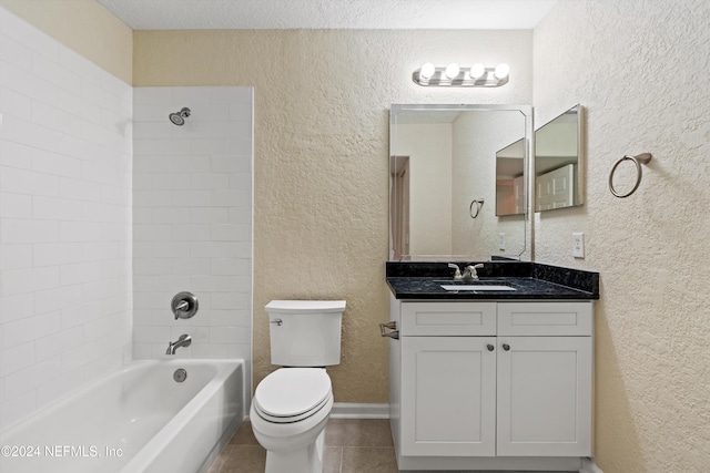 full bathroom featuring vanity, bathtub / shower combination, tile patterned floors, toilet, and a textured ceiling